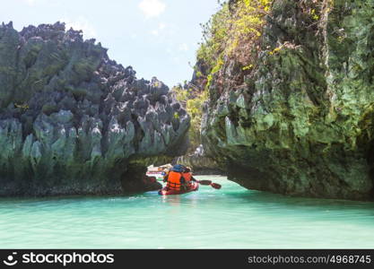 Kayak in the island lagoon between mountains. Kayaking journey in El Nido, Palawan, Philippines.