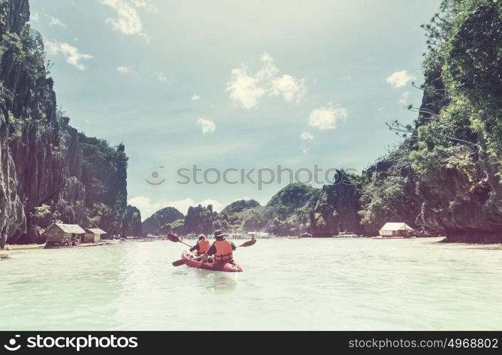 Kayak in the island lagoon between mountains. Kayaking journey in El Nido, Palawan, Philippines.