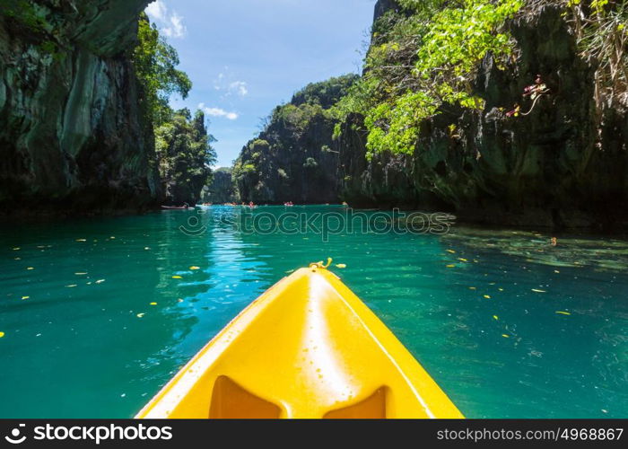 Kayak in the island lagoon between mountains. Kayaking journey in El Nido, Palawan, Philippines.