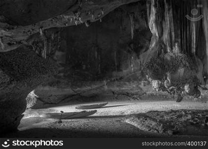 Kayak on sand beach inside sea cave exploring sea cave of Koh Talabeng near Koh Lanta, Krabi, Thailand