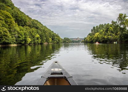 Kayak on the dordogne river by The picturesque medieval village of La Roque Gageac nestled in the cliff and reflecting in Dordogne river