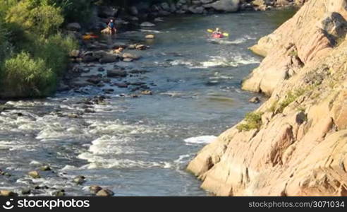 kayak rowers train pass rapids on the river