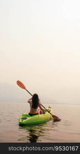 Kayak Water Sports at Lake. Kayakers enjoying the beautiful sunrise walks by sea kayak or canoe at tropical bay. relaxing with boat