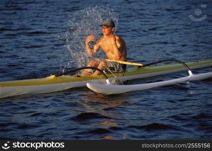 Kayaker outdoors splashing water on face