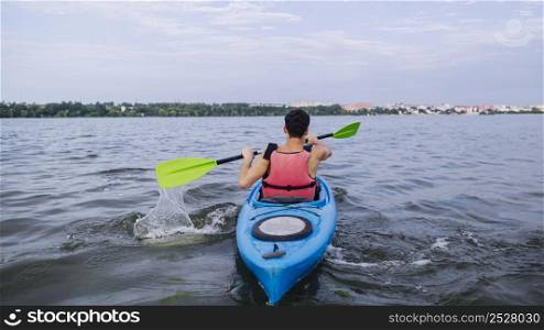 kayaker splashing water with paddle while kayaking