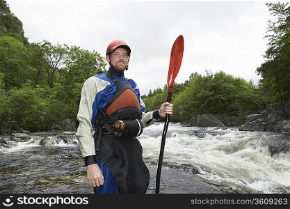 Kayaker Standing at Riverbank