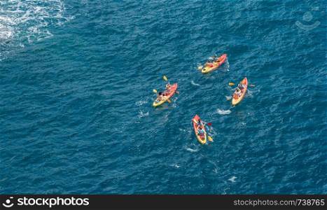 Kayakers or canoeists in the sea by the city walls in Dubrovnik. Canoes by the city walls of the old town of Dubrovnik in Croatia