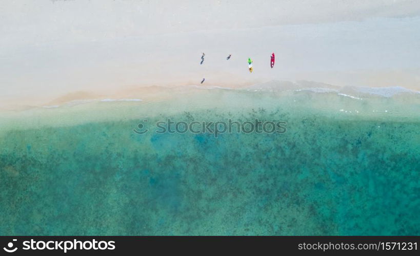 Kayaking and tourists on the beach aerial top view