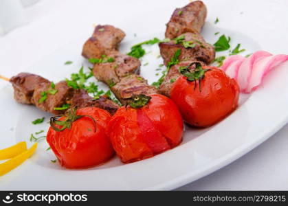 Kebab and tomatoes in the plate