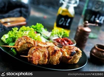 kebab and vegetable salad on plate., fried meat