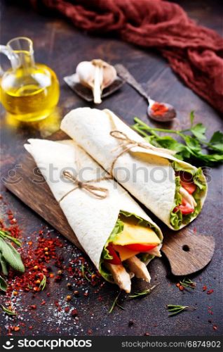 Kebab in a pancake with vegetables on a table