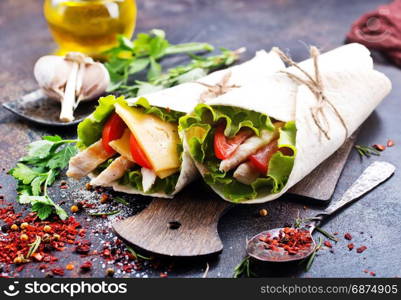 Kebab in a pancake with vegetables on a table