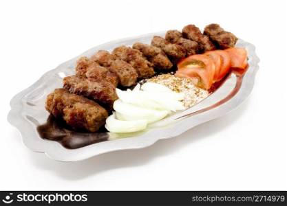 Kebabs with tomatoes and onion on silver dish