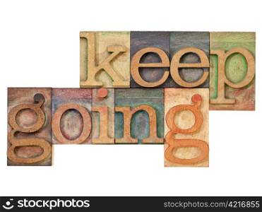 keep going - motivation concept - isolated text in vintage letterpress wood type