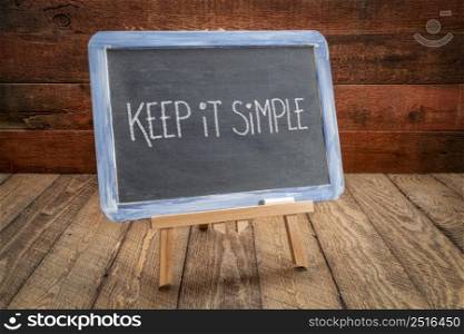 keep it simple inspirational reminder writing - white chalk on a slate blackboard, simplicity, minimalism and lifestyle concept