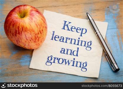 keep learning and growing inspirational advice - handwriting on a napkin with a an apple