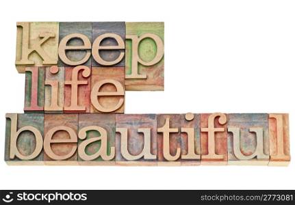 keep life beautiful - isolated text in vintage letterpress wood type stained by color inks