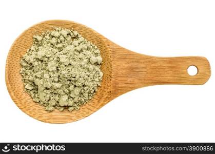 kelp seaweed powder - top view of a wooden spoon isolated on white