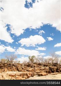 Kenya, Tsavo East National Park. A path in the middle of savanna with a wonderful blue sky