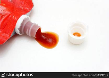 Ketchup in soft packing lies with an open white cover