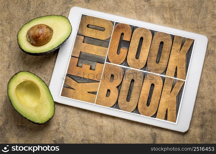 keto cookbook word abstract in letterpress wood type on a digital tablet with avocado, healthy diet and eating concept