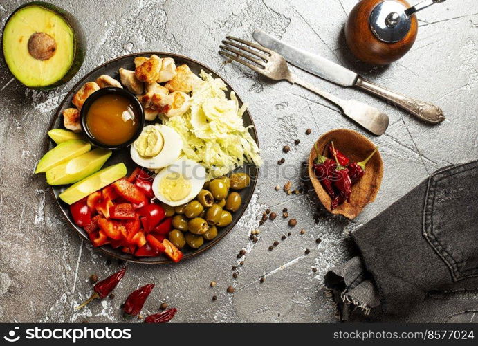 Ketogenic diet food, chicken fillet, quail eggs, avocado, spinach, walnut. healthy meal concept, Food recipe background. Close up top view.. diet food