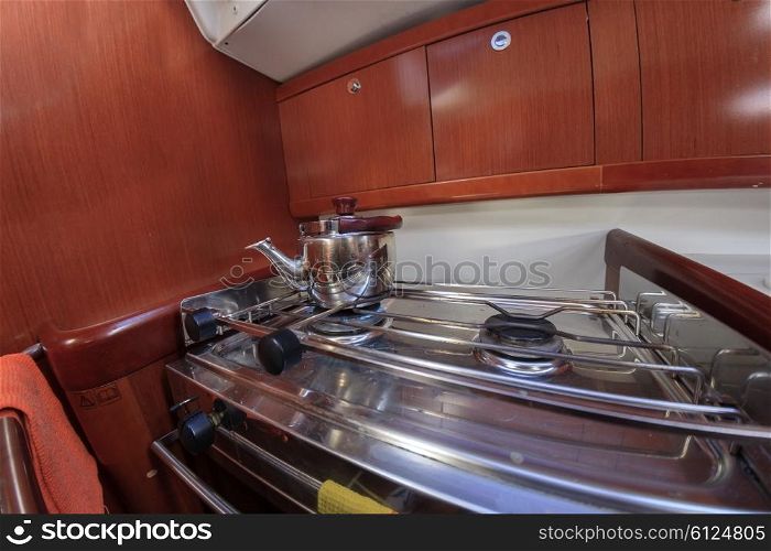 Kettle on gas stove at yacht kitchen&#xA;