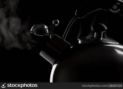 kettle. Tea kettle with boiling water over dark background