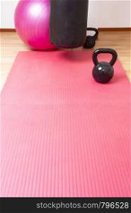Kettlebell and pink yoga mat on the floor, sport concept space for text. healthy lifestyle. Kettlebell and pink yoga mat on the floor, sport concept space for text