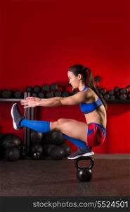 kettlebell woman pistol squat workout balance in red gym