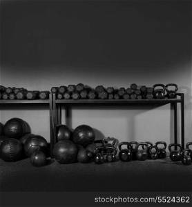 Kettlebells dumbbells and weighted slam balls weight training equipment at gym