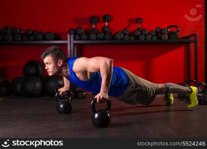 Kettlebells push-up man strength pushup exercise workout at gym