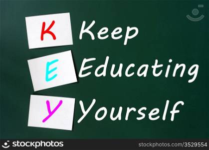 KEY acronym -Keep educating yourself on a green chalkboard with sticky notes