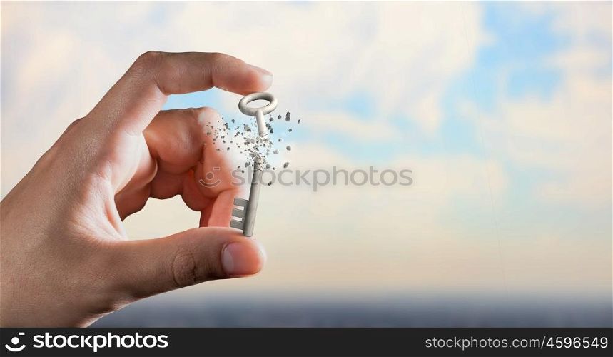 Key between fingers. Male hand taking key sign with fingers