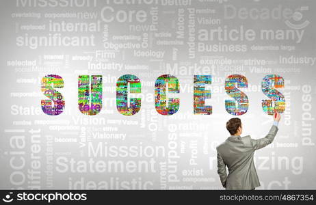 Key concepts to your success. Back view of businessman writing leadership concepts on wall