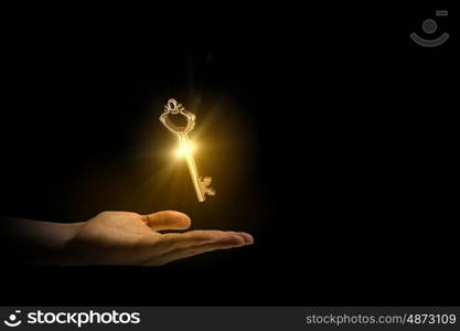 Key in hand. Close up image of business person holding shining key