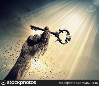 Key of success. Key in human hand. Struggle and success