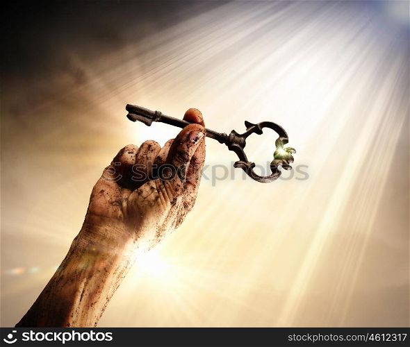 Key of success. Key in human hand. Struggle and success