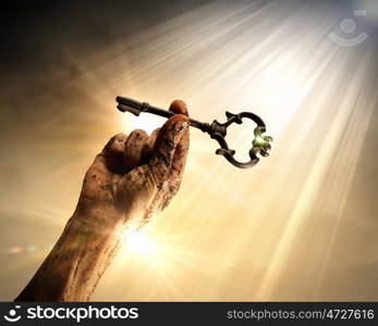 Key of success. Key in human hand. Struggle and success