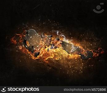 Key sign in fire flames. Key as security or success symbol burning in fire on dark background