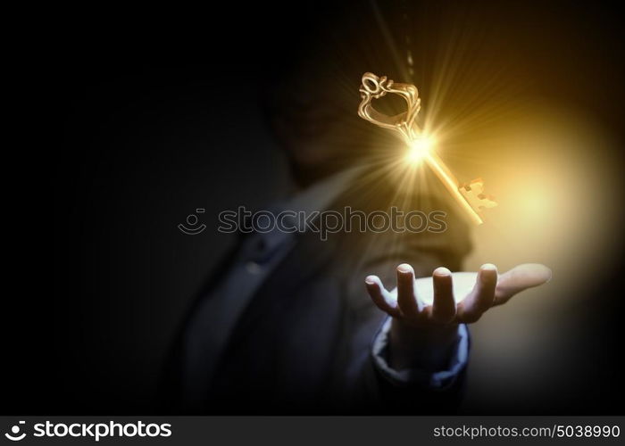 Key to success. Close up of businesswoman holding golden key in hand