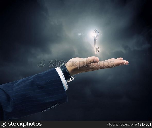 Key to success. Close up of human hand holding key