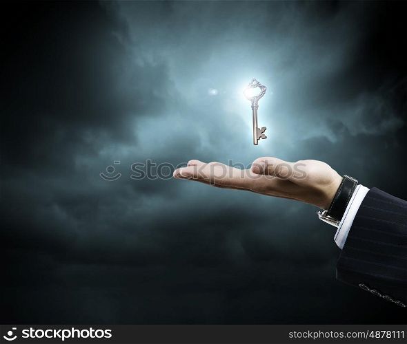 Key to success. Close up of human hand holding key