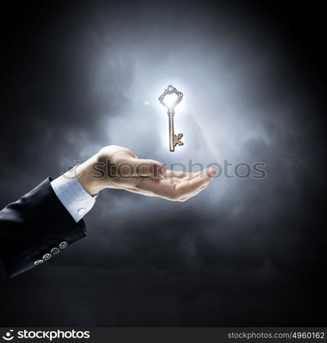 Key to success. Close up of human hand holding key