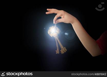 Key to success. Close up of woman hand holding golden key