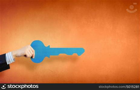 Key to success. Hand of business person holding key card