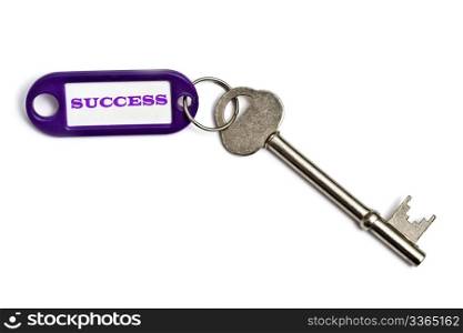 Key with a success tag closeup on white background