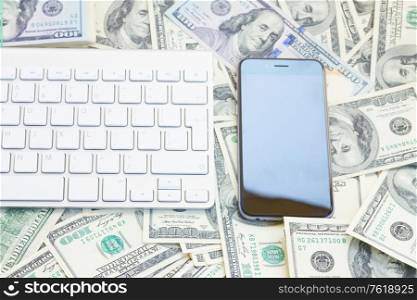 keyboard and modern smart phone on money background. keyboard and phone