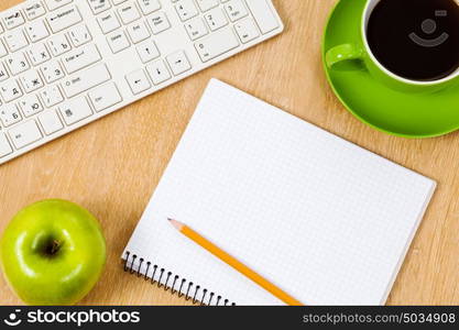 Keyboard cup of coffee and notepad at table. Work place