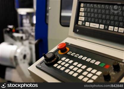 Keyboard on a control panel of CNC metalworking machine. Selective focus.